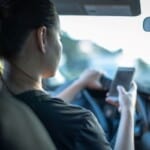 driver using phone | TechSplicit Driver is uing her phone, not payint attention to roads