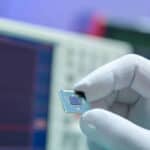 HandWithSmallElectronicMicrochipMicrocontroller | TechSplicit After Covid, MCU Makers Gambled … and Lost. What’s Next?