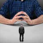 BusinessmanWithBowedHeadStandsInFrontOfACropped | TechSplicit American Tech CEOs are being Neutered